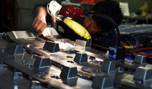 Technician working on car part