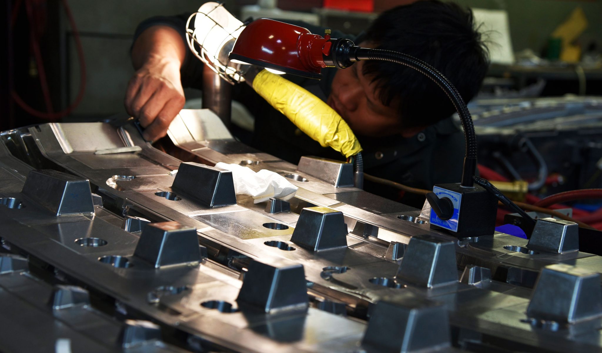 Technician working on car part